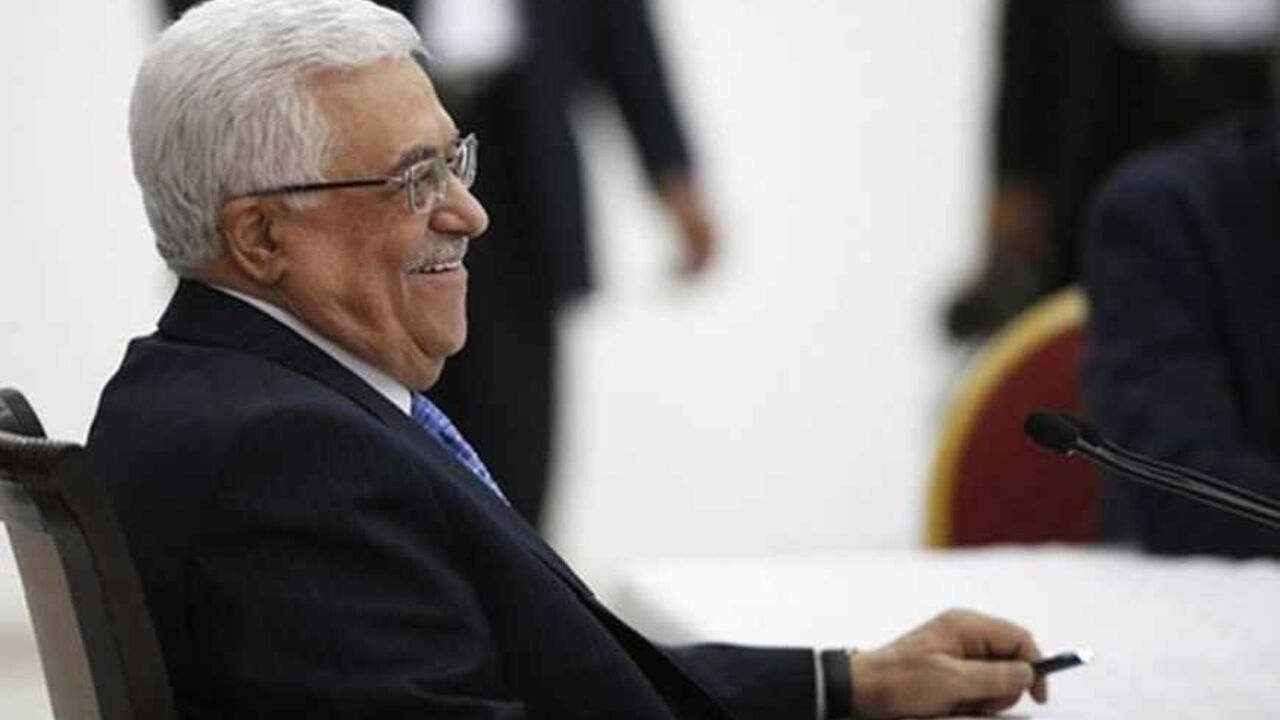 Palestinian President Mahmoud Abbas smiles during a meeting of the Palestinian leadership in the West Bank city of Ramallah July 18, 2013. As Palestinian leaders discussed a possible U.S-brokered resumption of peace talks on Thursday, the Israeli government denied a shift in its conditions that might help end a three-year stalemate. Abbas began briefing fellow PLO leaders in Ramallah on his meetings this week with U.S. Secretary of State John Kerry, who has extended his stay in the region and appears to be 