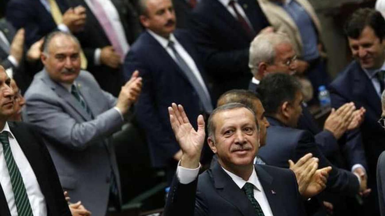 Turkey's Prime Minister Tayyip Erdogan (C) greets members of parliament from his ruling AK Party (AKP) during a meeting at the Turkish parliament in Ankara  June 25, 2013. Turkish anti-terrorism police detained 20 people in raids in the capital Ankara on Tuesday in connection with weeks of anti-government protests across the country, media reports said. The unrest began at the end of May when police used force against campaigners opposed to plans to redevelop a central Istanbul park. The protest spiralled i