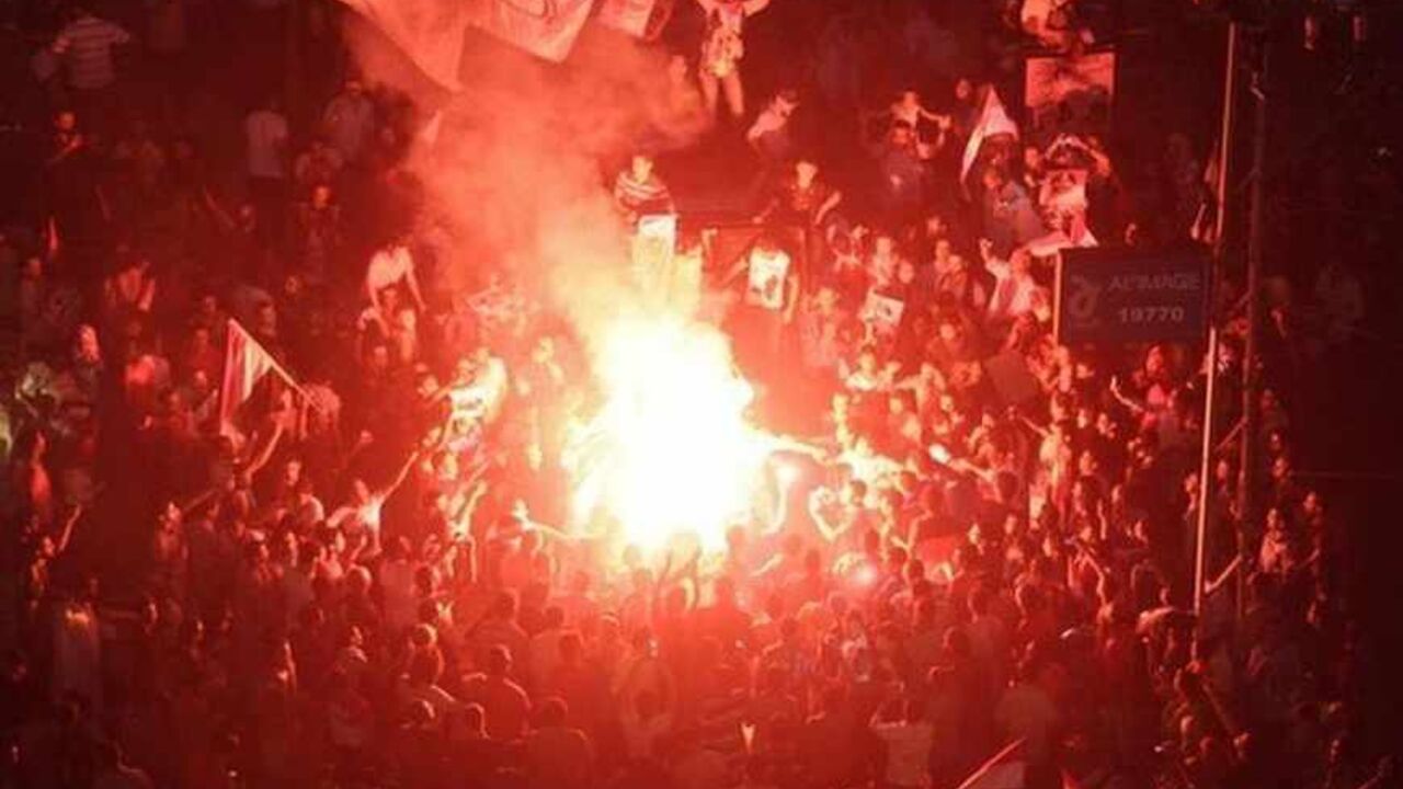 Protesters cheer and dance with flares as they gather for a mass protest to support the army in front of the presidential palace in Cairo July 26, 2013. At least seven people were killed and hundreds wounded in scattered violence across Egypt during mass rallies for and against the army's overthrow of Islamist President Mohamed Mursi, who was placed under investigation for murder. REUTERS/Asmaa Waguih (EGYPT - Tags: POLITICS CIVIL UNREST) - RTX120O6