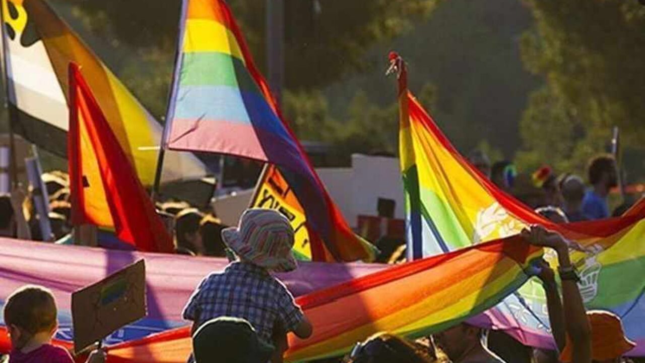 Participants hold rainbow flags during the 12th annual gay pride parade in Jerusalem August 1, 2013. Some 2500 people on Thursday took part in the annual parade in Jerusalem. REUTERS/Ronen Zvulun (JERUSALEM - Tags: SOCIETY) - RTX127G3