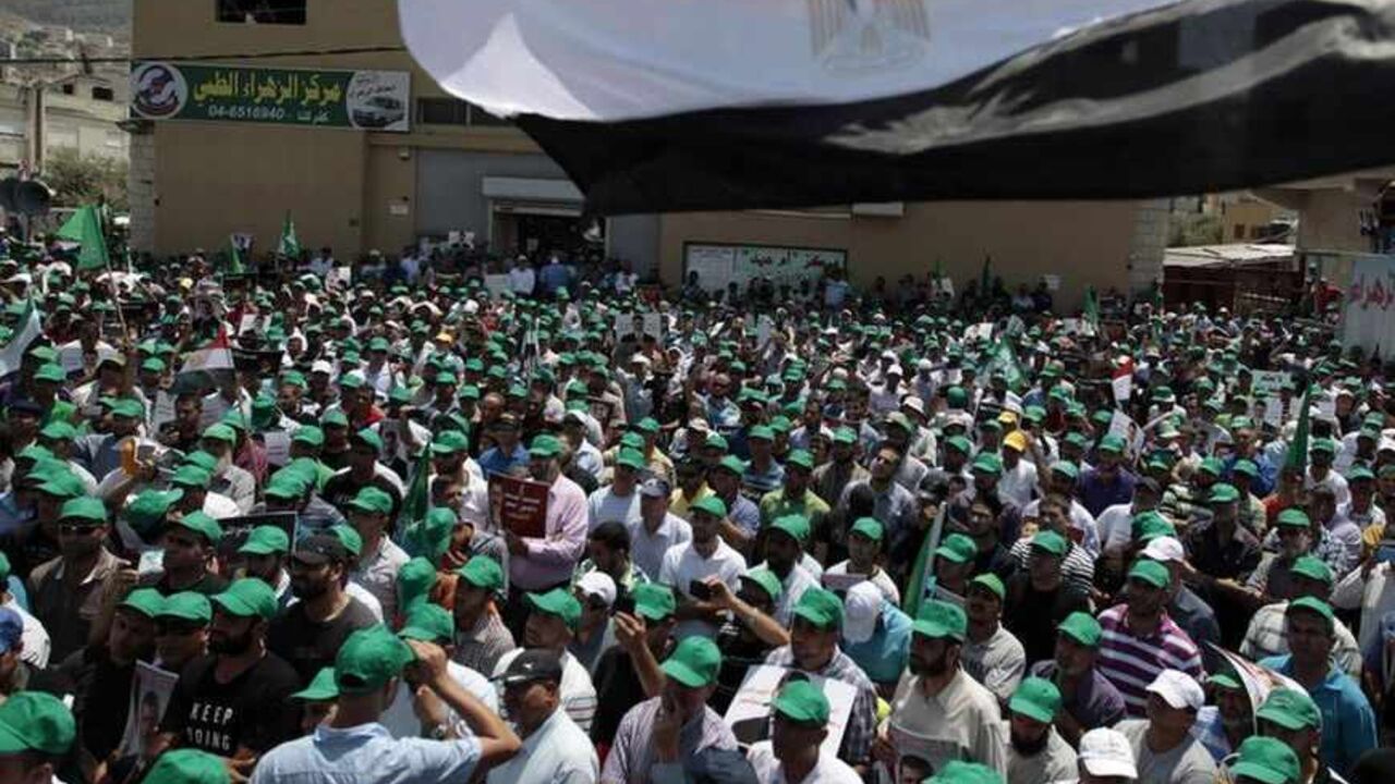 Israeli Arab men take part in a demonstration in support of the deposed Egyptian President Mohamed Mursi in the northern village of Kafar Kana July 13, 2013.      REUTERS/Ammar Awad (ISRAEL - Tags: CIVIL UNREST) - RTX11LTN