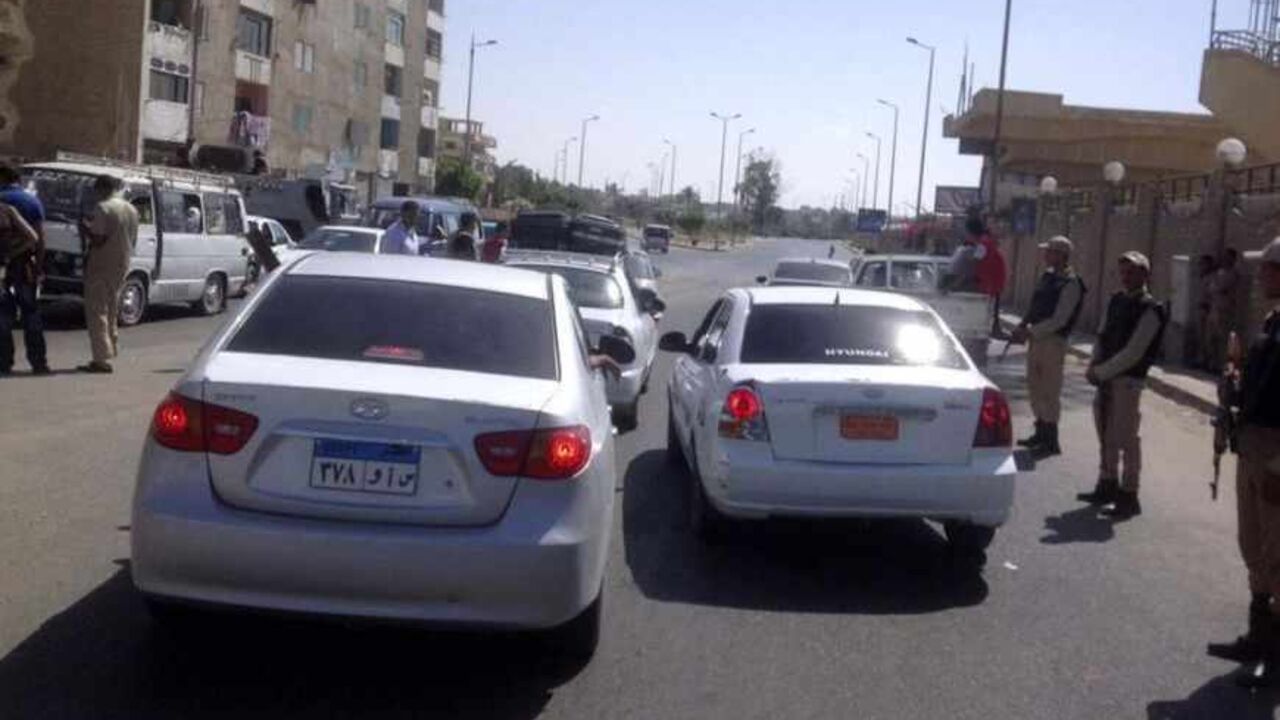 Army soldiers stand guard around the area where rocket-propelled grenades hit a bus in El-Arish city, North Sinai July 15, 2013. At least three people were killed and 17 wounded when suspected militants fired rocket-propelled grenades at a bus carrying workers in Egypt's North Sinai province early on Monday, security and medical sources said. REUTERS/Stringer (EGYPT - Tags: CIVIL UNREST POLITICS) - RTX11NA2