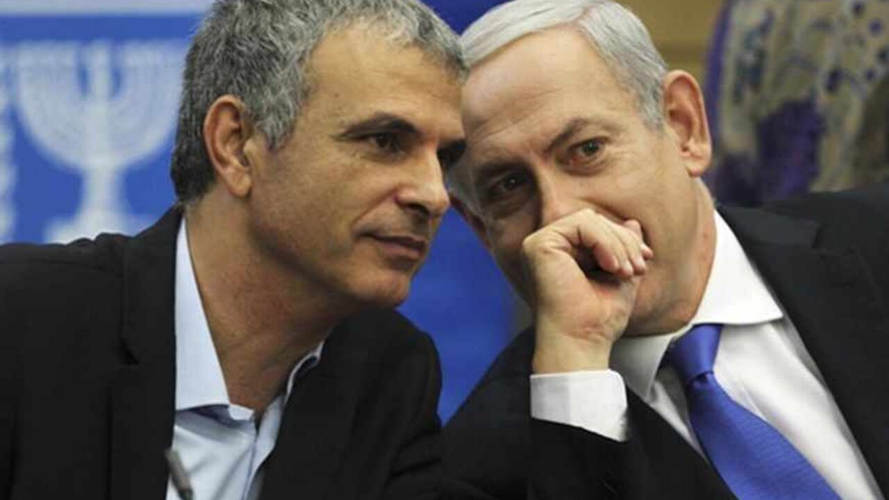 Moshe Kahlon, Israel's Communications and Social Welfare Minister (L) speaks with Prime Minister Benjamin Netanyahu during a Likud party meeting at the Knesset, the Israeli parliament, in Jerusalem October 15, 2012. Netanyahu's Likud party suffered a setback to its popularity on Monday following the announcement by Kahlon, one of the party's best appreciated ministers, that he would step down after an upcoming general election. REUTERS/Baz Ratner (JERUSALEM - Tags: POLITICS) - RTR3966V