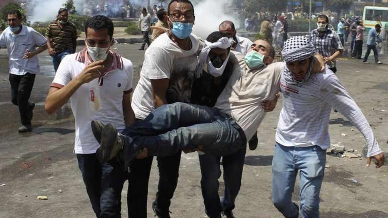 ATTENTION EDITORS - VISUAL COVERAGE OF SCENES OF INJURY OR DEATH

Supporters of deposed Egyptian President Mohamed Mursi carry a protester injured during clashes with riot police and army at around the area of Rabaa Adawiya square, where they are camping, in Cairo August 14, 2013. The death toll from an Egyptian police raid on supporters of Mursi at a Cairo protest camp has climbed to 60 at one hospital, according to a nurse who said she counted the bodies. REUTERS/Asmaa Waguih  (EGYPT - Tags: POLITICS CI