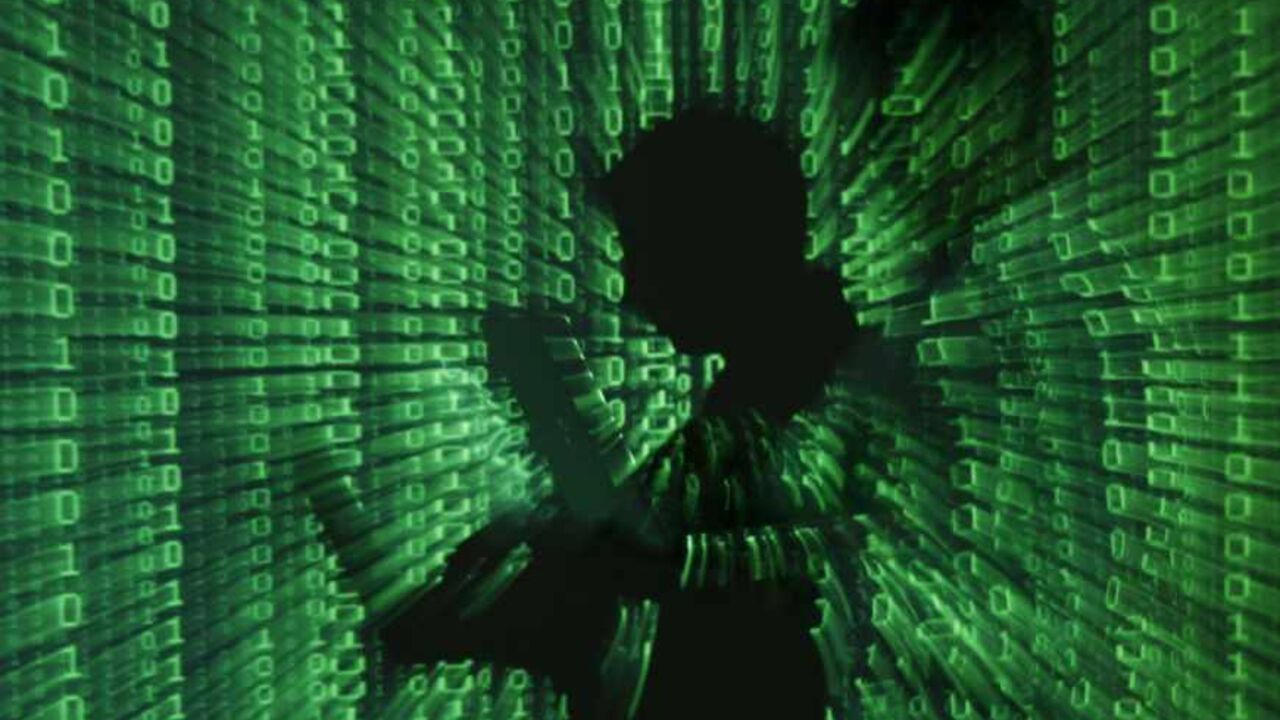 An illustration picture shows a projection of binary code on a man holding a laptop computer, in an office in Warsaw June 24, 2013. REUTERS/Kacper Pempel (POLAND - Tags: BUSINESS TELECOMS TPX IMAGES OF THE DAY) - RTX10ZB5