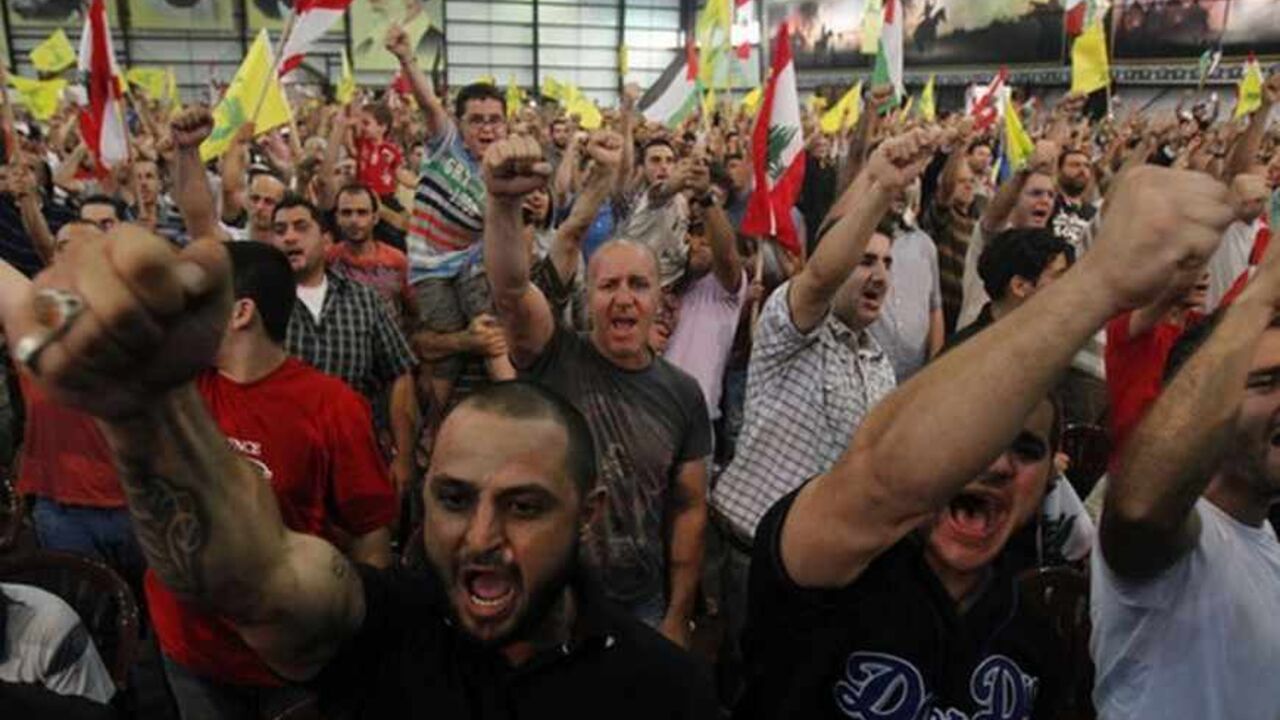 Hezbollah supporters react as they listen to their leader Sayyed Hassan Nasrallah during a rally to mark 'Quds (Jerusalem) Day' in Beirut's southern suburbs, August 2, 2013. Nasrallah delivered a speech to hundreds of supporters in support of Palestinians in his first public appearance since last September. He has been living in hiding, for fear of assassination, since Hezbollah fought a month-long war with Israel in 2006.  REUTERS/Sharif Karim   (LEBANON - Tags: POLITICS CIVIL UNREST ANNIVERSARY) - RTX128H