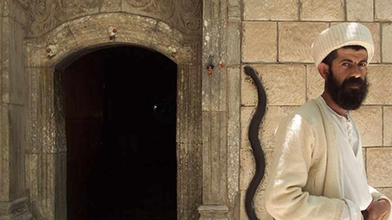 Yezidi monk Baba Chawish poses in front of an entrance to the Lalish
temple some 50 km north from Iraqi city of Mosul, May 11, 2003. The
Yezidi religion, seen by its followers as the original Kurdish faith,
is believed to date back several thousand years and blends ideas from
sources as diverse as Zoroastrianism, Islam and Christianity.
REUTERS/Shamil Zhumatov REUTERS

SZH/AS - RTRNBPT