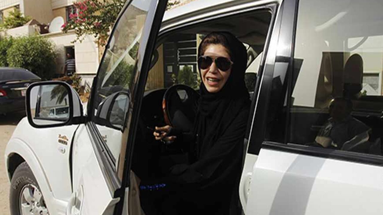 Female driver Azza Al Shmasani alights from her car after driving in defiance of the ban in Riyadh June 22, 2011. Saudi Arabia has no formal ban on women driving. But as citizens must use only Saudi-issued licences in the country, and as these are issued only to men, women drivers are anathema. An outcry at the segregation, which contributes to the general cloistering of Saudi women, has been fuelled by social media interest in two would-be female motorists arrested in May.REUTERS/Fahad Shadeed   (SAUDI ARA