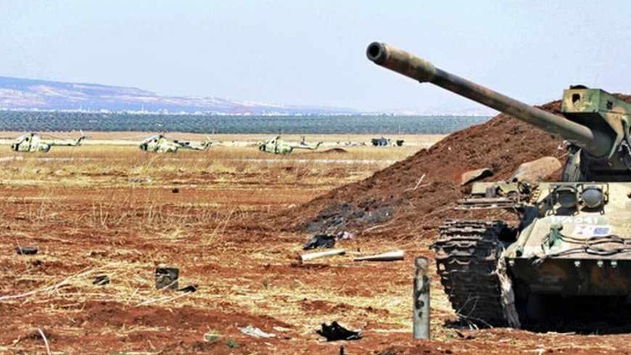 A tank and helicopters that belonged to the Syrian Army are seen at the Minnig military airport after it was seized by rebels, August 11, 2013. Syrian rebels captured the main military airport near the border with Turkey on August 6, consolidating their hold on a key supply route north of the city of Aleppo, opposition activists said. REUTERS/Mahmoud Hassano (SYRIA - Tags: CIVIL UNREST MILITARY TRANSPORT CONFLICT) - RTX12HMK