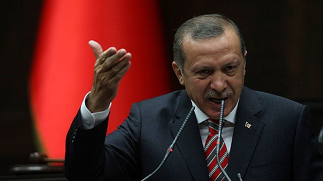 Turkish Prime Minister Tayyip Erdogan addresses members of parliament from his ruling Islamist-rooted Justice and Development Party (AKP) on Cctober 8, 2013 during a meeting at the parliament in Ankara. Turkey lifted on October 8 a ban on women wearing the Islamic head scarf in state institutions, ending a decades-old restriction as part of a package of reforms instigated by Erdogan.                   AFP PHOTO / ADEM ALTAN        (Photo credit should read ADEM ALTAN/AFP/Getty Images)