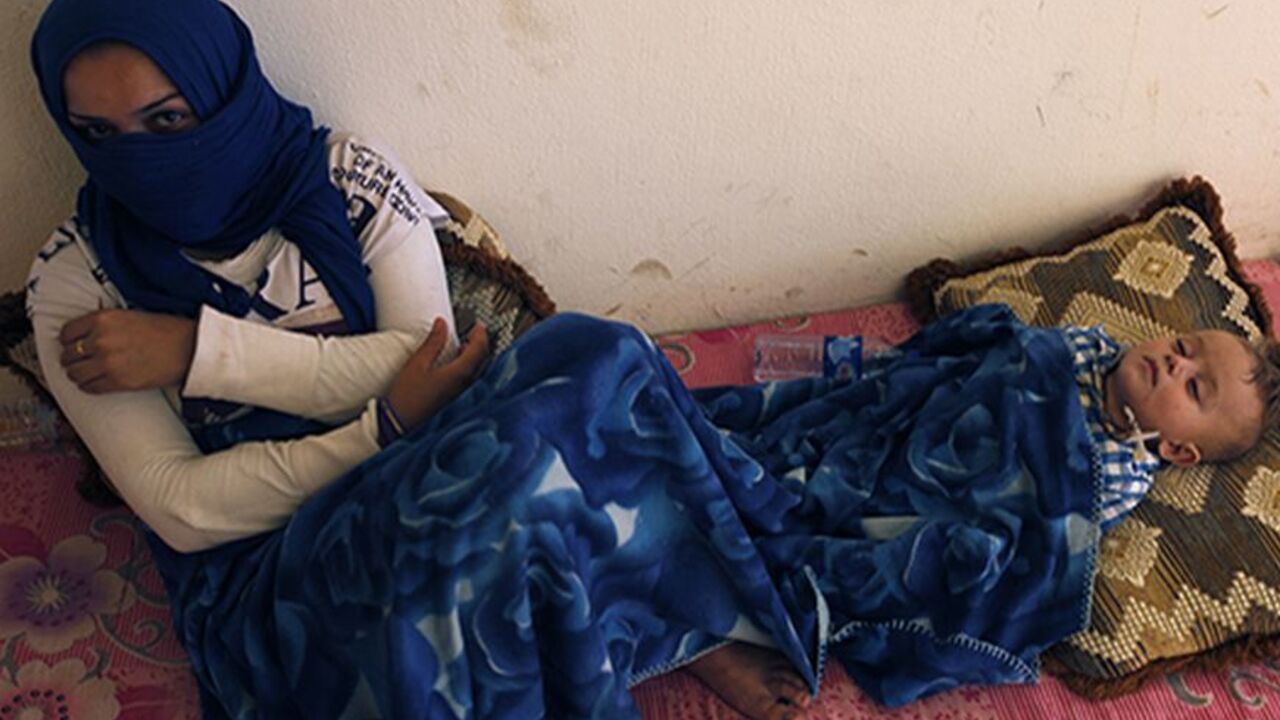 Syrian refugees, who fled the violence in Syria, are seen at a school that functions as a shelter for Syrian Kurdish refugees at Qushtapa at the outskirts of the city of Arbil in Iraq's Kurdistan region, August 23, 2013. The number of Syrian children forced to flee their devastated homeland reached 1 million on August 23, 2013, half of all the refugees driven abroad by a conflict that shows no sign of ending, the United Nations said. Another two million Syrian minors are uprooted within their country where 