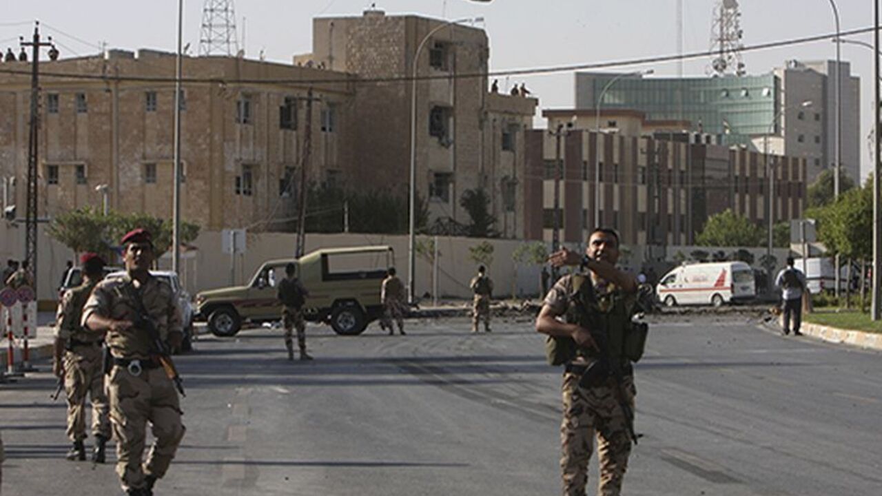 Kurdish security forces react after a bomb attack in the city of Arbil, the capital of the autonomous Kurdistan region, about 350 km (217 miles) north of Baghdad, September 29, 2013. Six people were killed on Sunday in a series of explosions outside a security directorate in the capital of Iraq's usually peaceful autonomous Kurdistan region, security and medical sources said. Gunfire could be heard after the blasts in Arbil that wounded a further 36 people, according to the city's health directorate. The vi