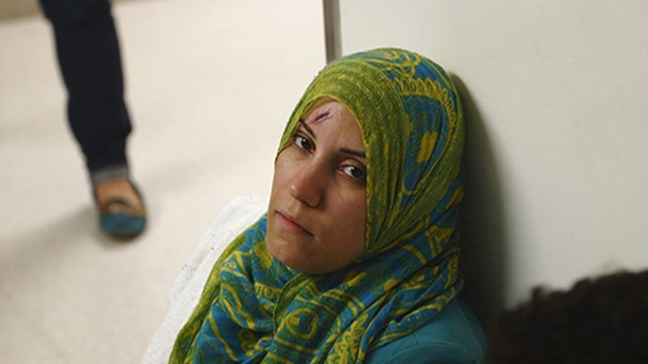 A rescued migrant sits in a corridor while waiting to undergo preliminary medical tests at Mater Dei Hospital in Tal-Qroqq, outside Valletta, October 12, 2013. Italian calls for Europe to do more on the migrant crisis grew on Saturday and Malta's prime minister said the Mediterranean was becoming a "cemetery" after another boat sank off Sicily, killing dozens more people. Italian and Maltese navy ships recovered 34 bodies and rescued 206 migrants after their boat sank about 60 nautical miles south of Sicily
