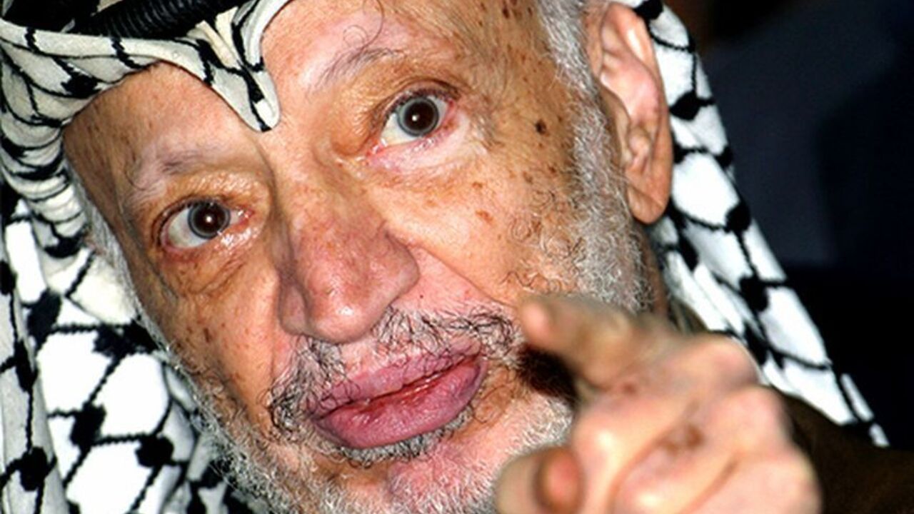 Palestinian President Yasser Arafat talks to the media after opening a voter registration drive at a polling station at his headquarters in Ramallah.  Palestinian President Yasser Arafat talks to the media after opening a voter registration drive at a polling station at his headquarters in the West Bank city of Ramallah September 4, 2004. Palestinians began registering voters for an as yet unscheduled general election on Saturday, in the first concrete step to meet long-standing international and domestic d