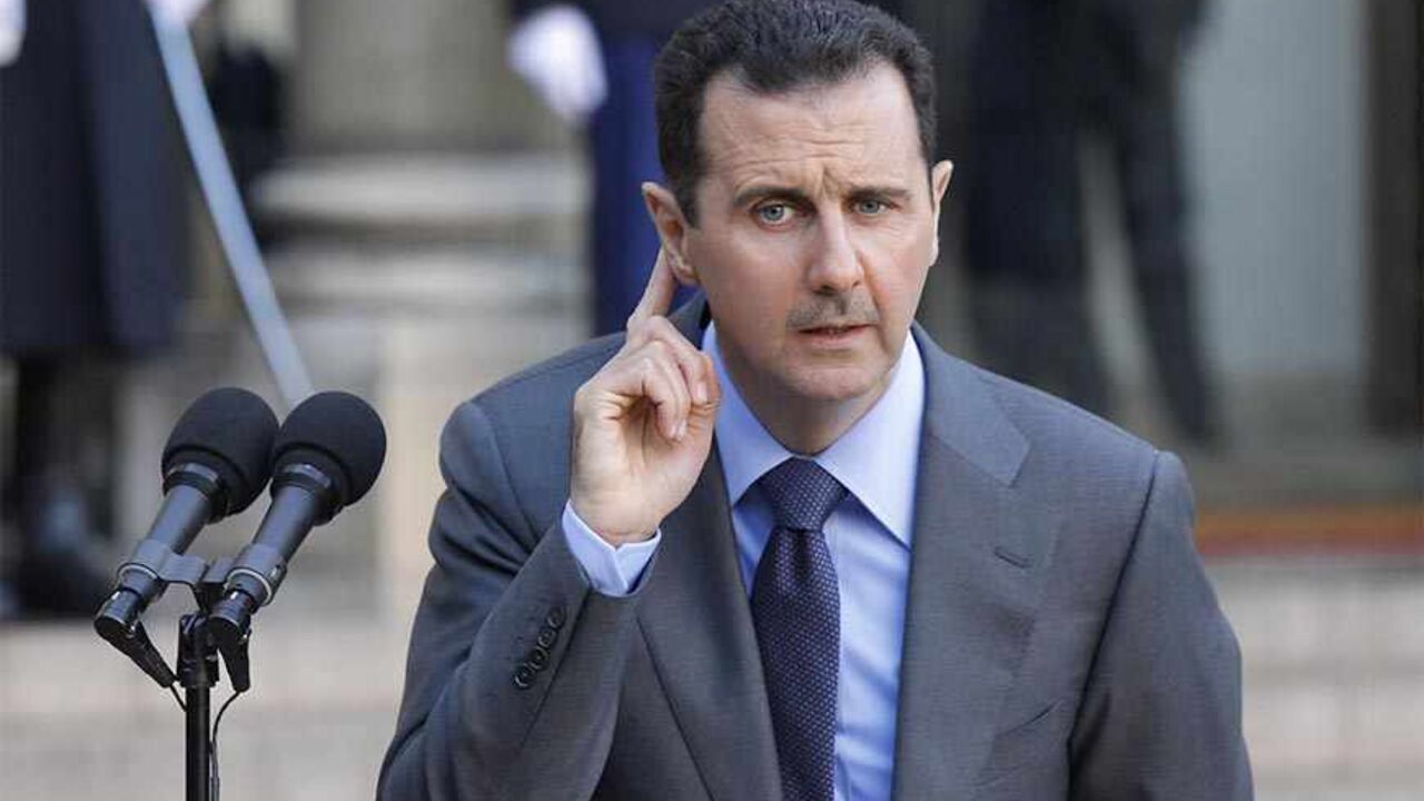 Syria's President Bashar al-Assad answers journalists after a meeting at the Elysee Palace in Paris, December 9, 2010. REUTERS/Benoit Tessier (FRANCE - Tags: POLITICS) - RTXVKF9