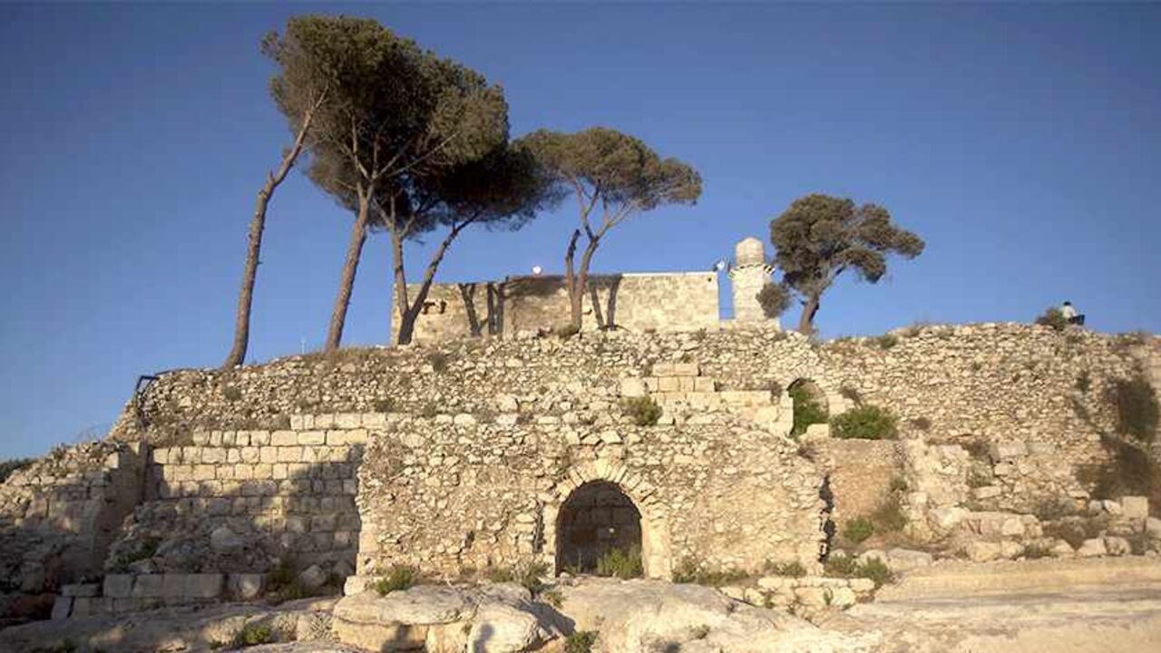 The shadows of ultra-Orthodox Jewish men are cast on the ground as they arrive to Samuel's Tomb on the outskirts of Jerusalem on May 12, 2010. Thousands of Jews marked the anniversary of biblical prophet Samuel's death. AFP PHOTO/MENAHEM KAHANA (Photo credit should read MENAHEM KAHANA/AFP/Getty Images)