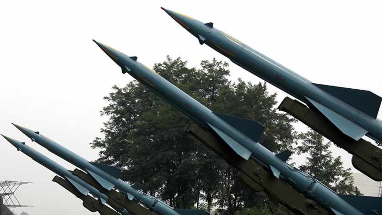 Visitors to the China Aviation Museum located on the outskirts of Beijing walk under old missiles on display August 17, 2010. China is expanding its military edge over Taiwan, increasing the lethality of its short-range ballistic missiles while raising the risk of "misunderstanding and miscalculation," the Pentagon said on Monday, just a day after a leading armed forces newspaper said that China's military thinking is outmoded and they should learn from others, especially the United States, when it comes to