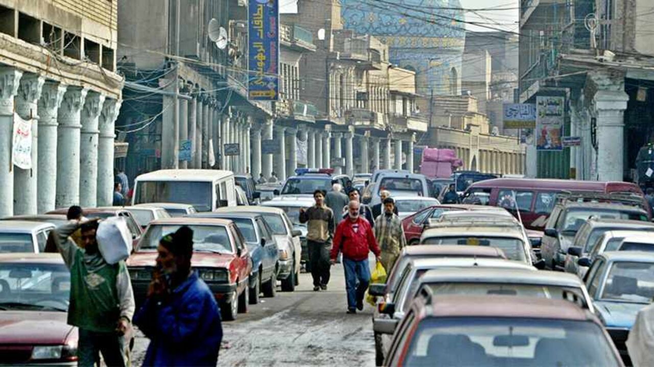 Iraqis walk down Al-Rashid Street in the capital Baghdad, January 2, 2005. Rashid Street, the once vibrant heart of the city, has been in sad decline for decades, its intellectual life choked by repression, its cafes and stores strangled by war and sanctions. But it has taken the anarchy, crime and guerrilla violence unleashed after the U.S. overthrow of Saddam Hussein to kill off what was left of Rashid Street's colonnaded, Ottoman-era charm. TO ACCOMPANY FEATURE STORY BC-IRAQ-STREET  REUTERS/Faleh Kheiber