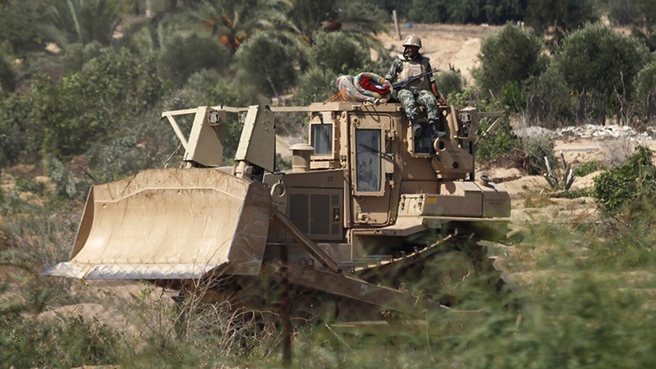 An Egyptian soldier sits atop a bulldozer on the border between Egypt and southern Gaza Strip September 12, 2013. Cairo closed the Rafah crossing, Gaza's main window to the world, completely on Wednesday after assailants crashed two explosive-laden cars into a security building adjacent to the border zone, killing six Egyptian soldiers. The bulldozing of the tunnels has deepened Gaza residents' feelings of isolation in a tiny coastal territory that many have described as a prison. Egypt has suggested Palest