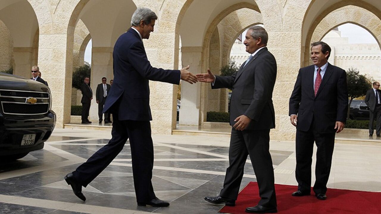 Jordan's Foreign Minister Nasser Judeh (C) welcomes U.S. Secretary of State John Kerry upon his arrival at the Royal Palace in Amman, to meet with Jordan's King Abdullah, November 7, 2013. At right is U.S. Ambassador to Jordan Stuart Jones. REUTERS/Muhammad Hamed (JORDAN - Tags: POLITICS) - RTX153OT
