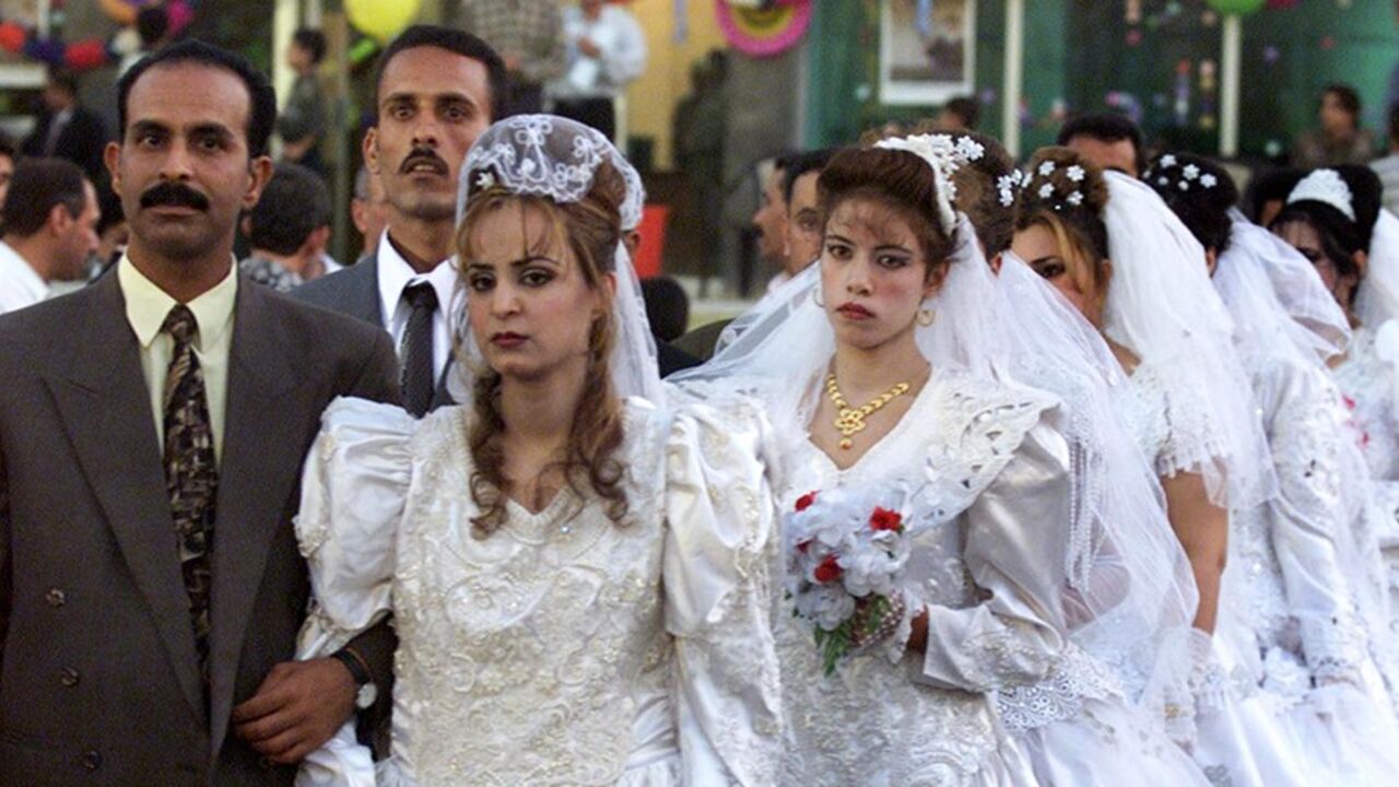 A mass wedding organised by the government takes place in Baghdad
October 15, 2001. Many Iraqis opt for a mass marriage due to economic
restrictions. REUTERS/ Faleh Kheiber REUTERS

FK/FMS - RTRO628