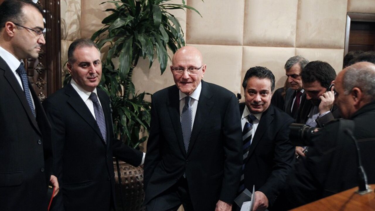 Lebanon's Prime Minister Tammam Salam (C) walks at the presidential palace in Baabda, near Beirut February 15, 2014. Lebanon announced a new government on Saturday, breaking a 10-month political deadlock during which spillover violence from neighbouring Syria worsened internal instability. Parliament designated Sunni lawmaker Salam as prime minister in April 2013, but he had been unable to form a government for months due to rivalries between the Hezbollah-dominated March 8 bloc and the March 14 alliance, l