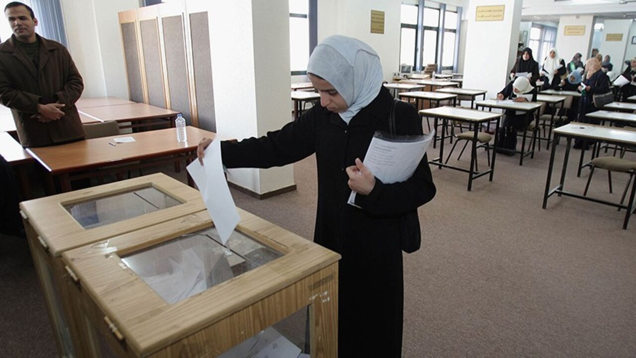 GAZA CITY, GAZA STRIP - MARCH 14: Palestinian students vote during student council election at the Islamic University on March 14, 2005 in Gaza City, Gaza Strip. The Hamas supporting Yassien List won 83.65%, defeating the Mahmoud Abbas supporting Shuhada Falasten List who gained 10.5% of the vote. An estimated 71 % of 14678 students voted in the council election at the Islamic University. (Photo by Abid Katib/Getty Images) 