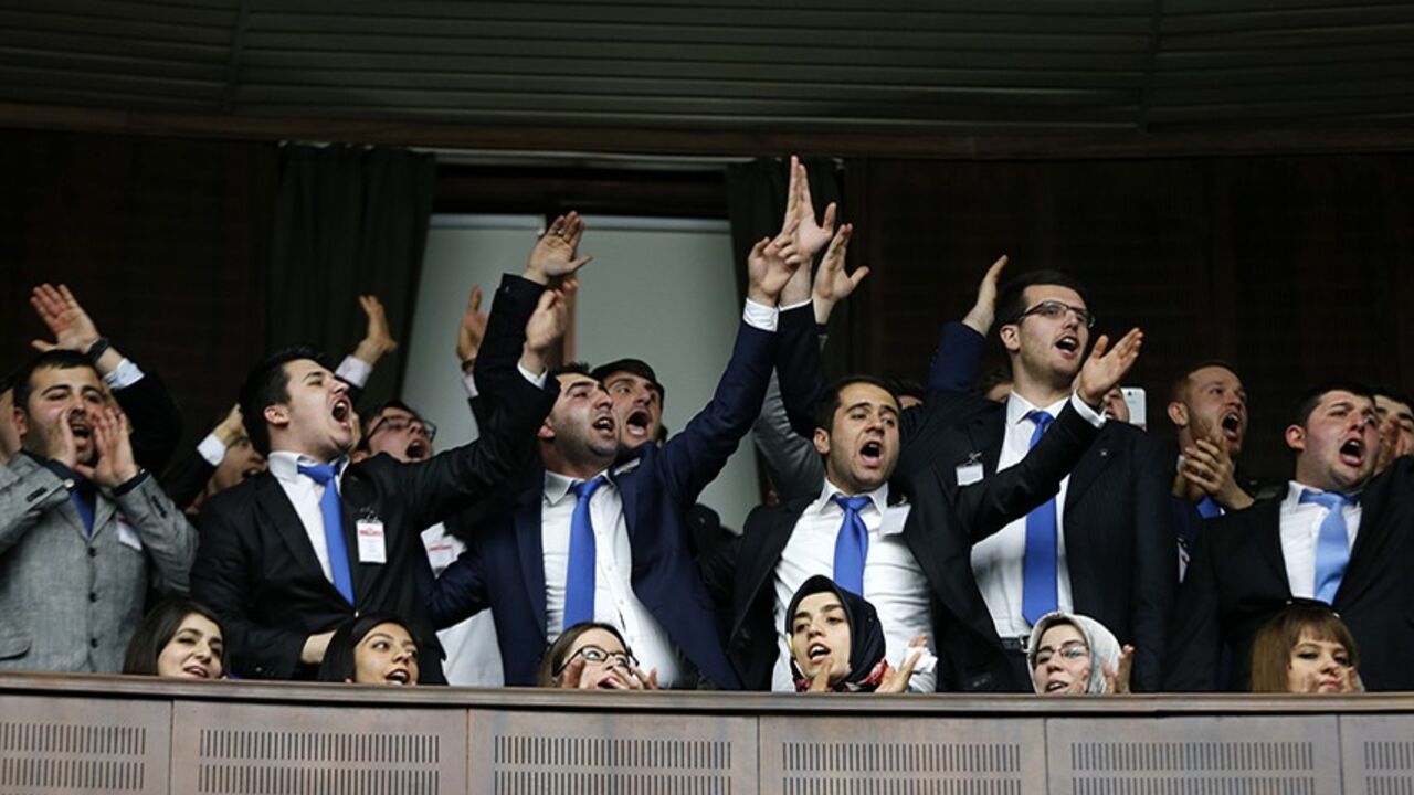 Supporters of Turkey's Prime Minister Tayyip Erdogan react as he addresses the audience during a meeting at the Turkish parliament in Ankara February 25, 2014. Erdogan said on Tuesday voice recordings purportedly of him telling his son to dispose of large sums of money on the day news broke of a graft inquiry were a "treacherous attack" on his office. In a speech to his ruling AK Party deputies in parliament, Erdogan also said the recordings, which appeared on YouTube late on Monday, were a "shameless monta