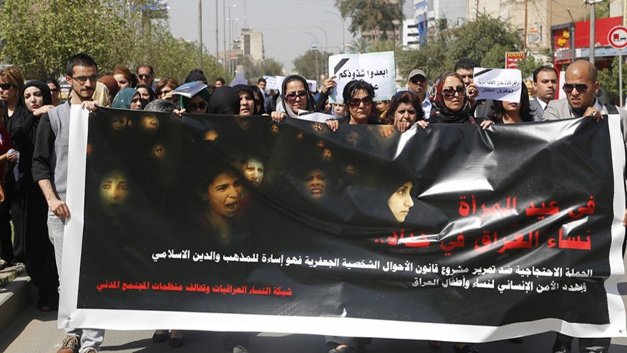Iraqi Protesters hold a banner during a demonstration against the draft of the "Al-Jafaari" Personal Status Law during International Women's Day in Baghdad March 8, 2014. Protesters say the law, which involves the use of Shi'ite Jafaari law with regards to divorce, marriage and inheritance, will restrict their personal rights, according to local media. On March 8 activists around the globe celebrate International Women's Day, which dates back to the beginning of the 20th Century and has been observed by the