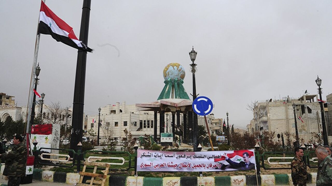 A banner of Syria's President Bashar al-Assad is seen at a Yabroud town square in the Damascus countryside, after the soldiers loyal to Assad took control of it from the rebel fighters, in this handout released by Syria's national news agency SANA on March 17, 2014. REUTERS/SANA/Handout via Reuters (SYRIA - Tags: CIVIL UNREST POLITICS CONFLICT ) ATTENTION EDITORS - THIS IMAGE WAS PROVIDED BY A THIRD PARTY. FOR EDITORIAL USE ONLY. NOT FOR SALE FOR MARKETING OR ADVERTISING CAMPAIGNS. THIS PICTURE IS DISTRIBUT