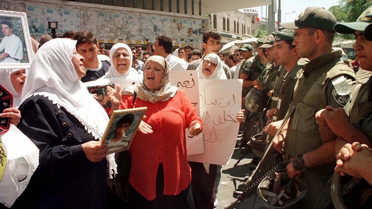 Israeli Border Policemen keep watch over several dozen Palestinians demonstrating in Jerusalem June 28. Palestinian women chanting slogans and holding pictures of their sons demonstrated in Arab East Jerusalem calling for Israel to free their relatives who are being held as political prisoners. More than 5,000 Palestinians prisoners are held in Israeli jails.

MIDEAST - RTR4VBH