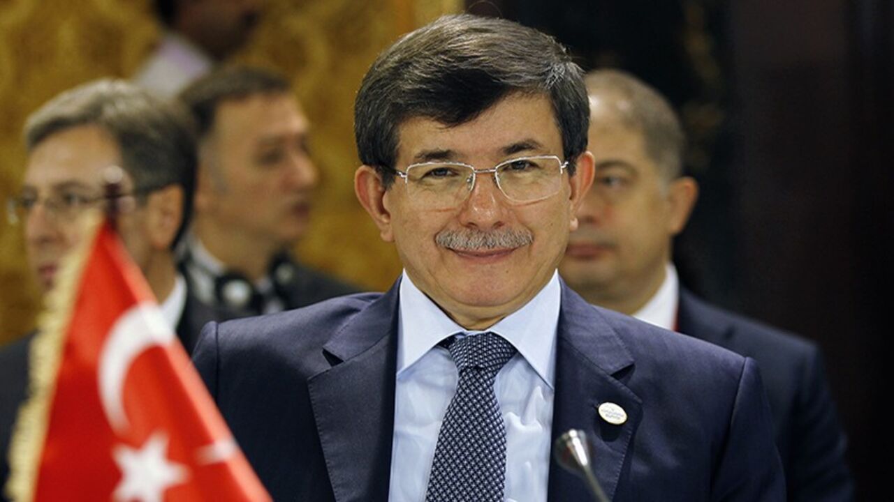 Turkish Foreign Minister Ahmet Davutoglu smiles at photographers during the 12th Asia Cooperation Dialogue Ministerial Meeting in Manama November 25, 2013. REUTERS/Hamad I Mohammed (BAHRAIN - Tags: POLITICS) - RTX15SAF