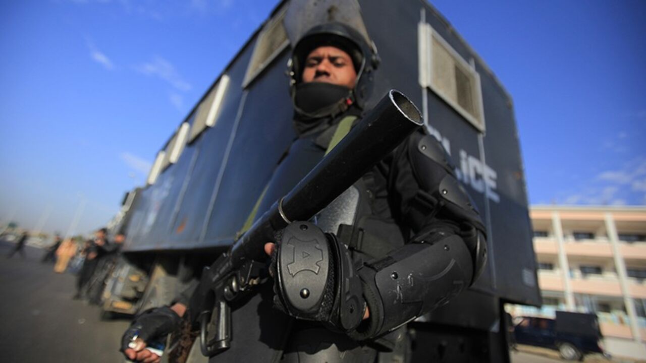 A riot police officer stands guard outside a police academy, where ousted Egyptian President Mohamed Mursi's second trial session was due to take place, on the outskirts of Cairo January 8, 2014. Mursi's arrival at the Cairo court where he was due to stand trial on Wednesday was delayed by poor weather, state TV reported. Mursi was due to be flown to the Cairo police academy where the court was due to convene. Mursi is currently in a jail near the Mediterranean city of Alexandria. REUTERS/Amr Abdallah Dalsh