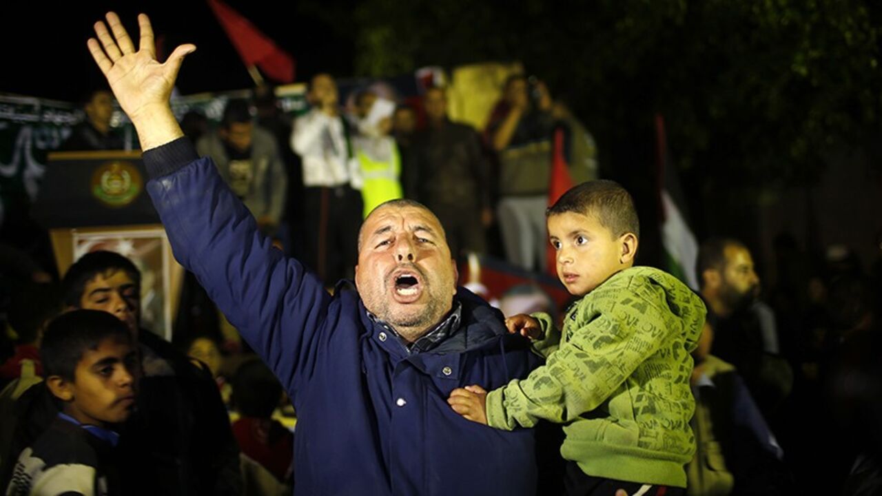 A Palestinian Hamas supporter celebrates after Erdogan declared victory in local polls during a rally organised by Hamas movement in the northern Gaza Strip March 31, 2014. Turkish Prime Minister Tayyip Erdogan declared victory in local polls that had become a referendum on his rule and said he would "enter the lair" of enemies who have accused him of corruption and leaked state secrets. The Arabic words read "Turkey Justice and development forward". REUTERS/Mohammed Salem (GAZA - Tags: POLITICS CIVIL UNRES