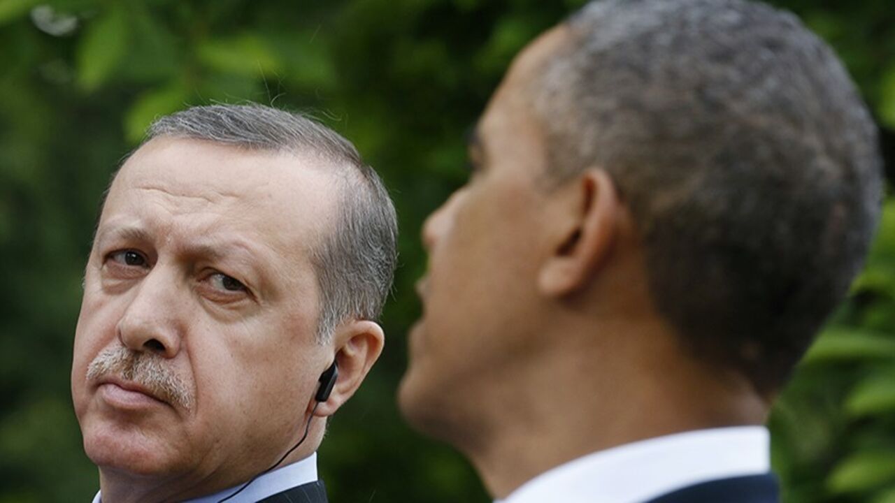 Turkish Prime Minister Recep Tayyip Erdogan (L) listens as U.S. President Barack Obama (R) addresses a joint news conference in the White House Rose Garden in Washington, May 16, 2013.   REUTERS/Kevin Lamarque (UNITED STATES  - Tags: POLITICS)   - RTXZPBL