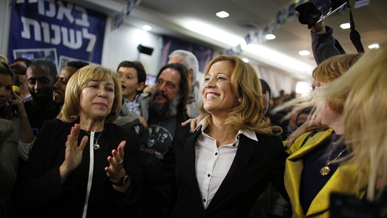 Dr. Aliza Lavie (C), a Yesh Atid (There's a future) party candidate, celebrates exit poll results at the party's headquarters in Tel Aviv January 22, 2013. Israel's parliament, long heavy with retired generals, is getting a new look, with a freshman class that includes two youth protest leaders, an Ethiopian immigrant, a high tech millionaire and more women than ever. Thanks to the surprise second place finish of Yesh Atid, as well as the success of a new far-right group, the 120-member Knesset will have a 