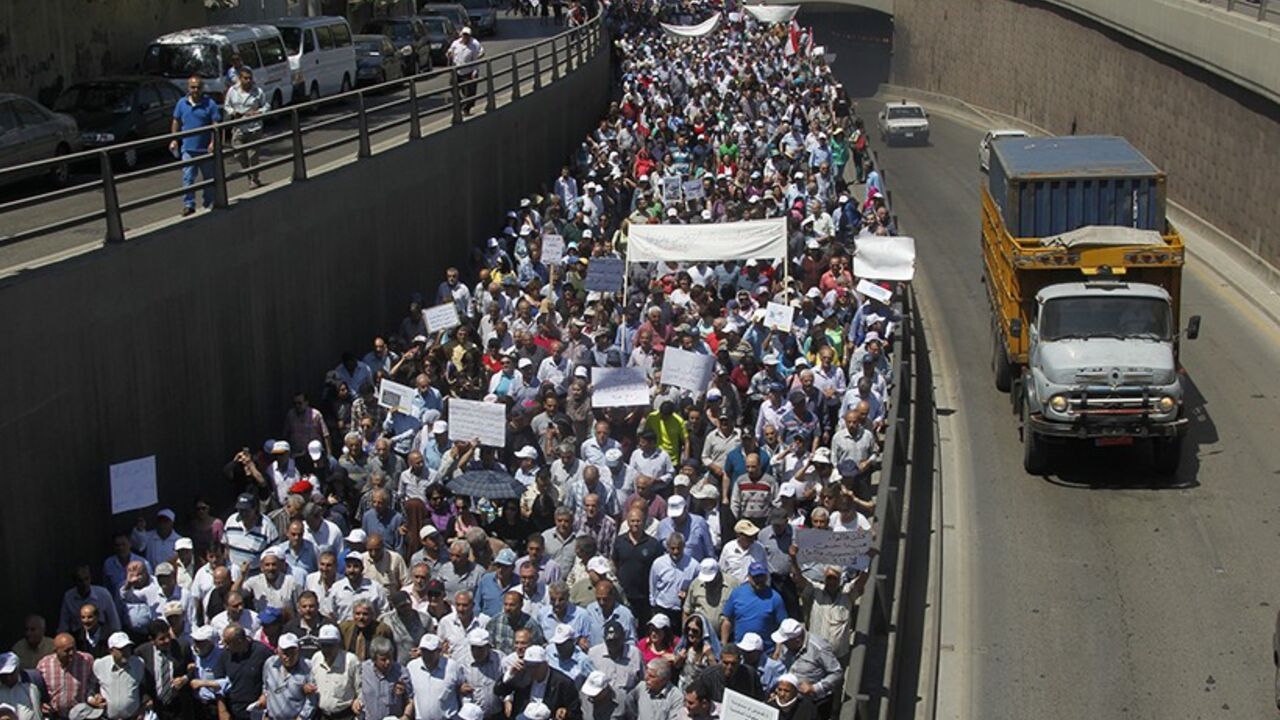 Thousands of Lebanon's public sector employees march through Beirut to demand the parliament to approve a new salary scale law which if passed means a significant wages increase, April 29, 2014. The Union Coordination Committee (UCC) kicked off its demonstration on Tuesday from the Lebanese Central Bank in Hamra towards the Chamber of Trade and Commerce in Sanayeh. The demonstrators called on the Central Bank Governor and concerned sides to meet their demands,  the National News Agency (NNA) reported. REUTE