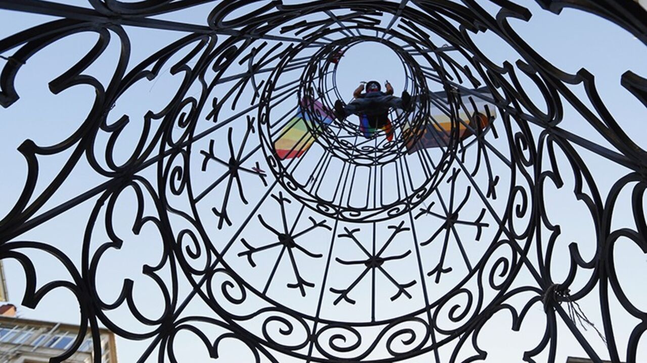 A gay rights activist waves a rainbow flag during a protest at Tunel Square in Istanbul June 23, 2013.  REUTERS/Marko Djurica (TURKEY - Tags: SOCIETY CIVIL UNREST) - RTX10Y6T