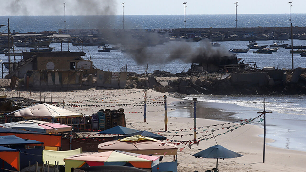 Smoke billows from a beach shack following an Israeli military strike, on July 16, 2014 in Gaza City which killed four children, medics said. All four were on the beach when the attack took place, emergency services spokesman Ashraf al-Qudra said, with several injured children taking refuge at a nearby hotel where journalists were staying. AFP PHOTO / THOMAS COEX        (Photo credit should read THOMAS COEX/AFP/Getty Images)