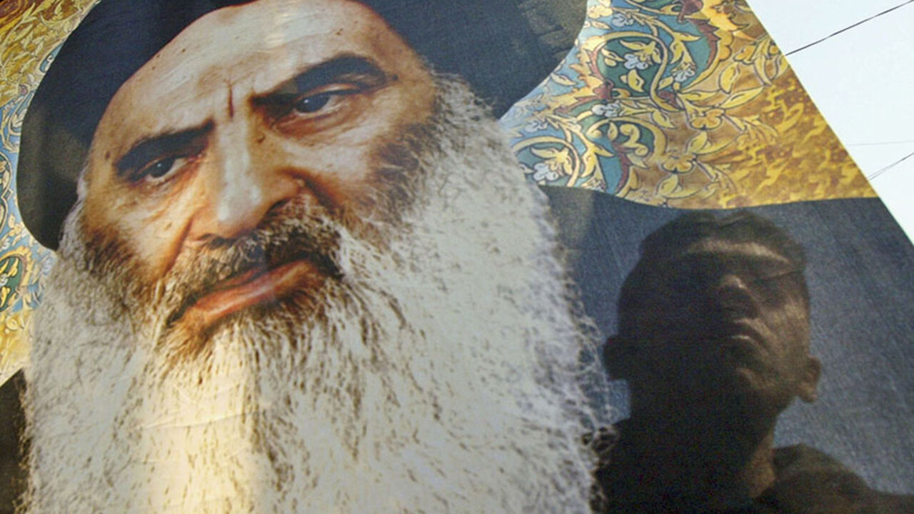 BAGHDAD, IRAQ - FEBRUARY 23 : An Iraqi Shiite man carries a picture of Iraq's powerful Shiite cleric Grand Ayatollah Ali al-Sistani as he takes part in a protest  against the bombing of a Shiite holy shrine  on February 23, 2006 in the Karradah district in Baghdad, Iraq. Protests against the bombing  of the Askariya golden dome  Shiite holy shrine continue in Baghdad and other Shiite cities around the country for the second day. The Askariya golden-dome  shrine, which hosts the tombs of Imam Ali al-Hadi and