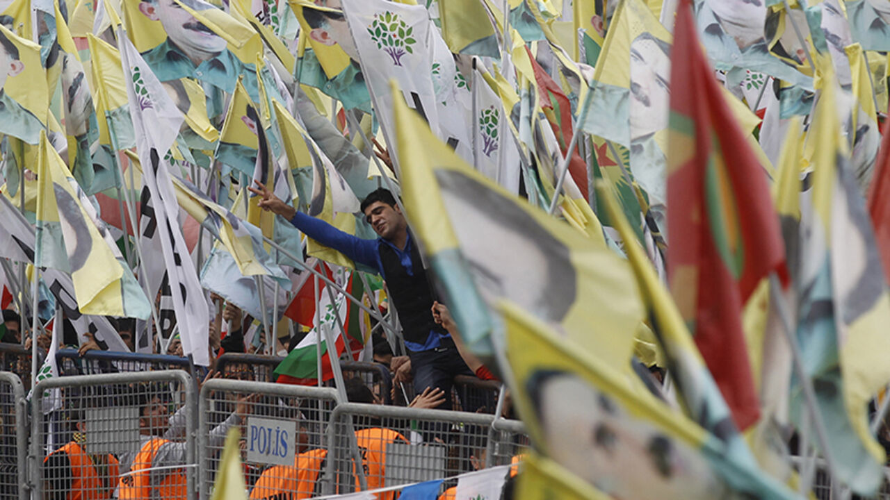 People take part in a gathering to celebrate Newroz, which marks the arrival of spring and the new year in Istanbul March 23, 2014. Jailed Kurdish militant leader Abdullah Ocalan of the Kurdistan Workers Party (PKK) called on the Turkish government on Friday to create a legal framework for their peace talks, whose fate is looking increasingly uncertain a year after he called a ceasefire by his fighters. REUTERS/Osman Orsal (TURKEY - Tags: POLITICS SOCIETY ANNIVERSARY) - RTR3I8YF