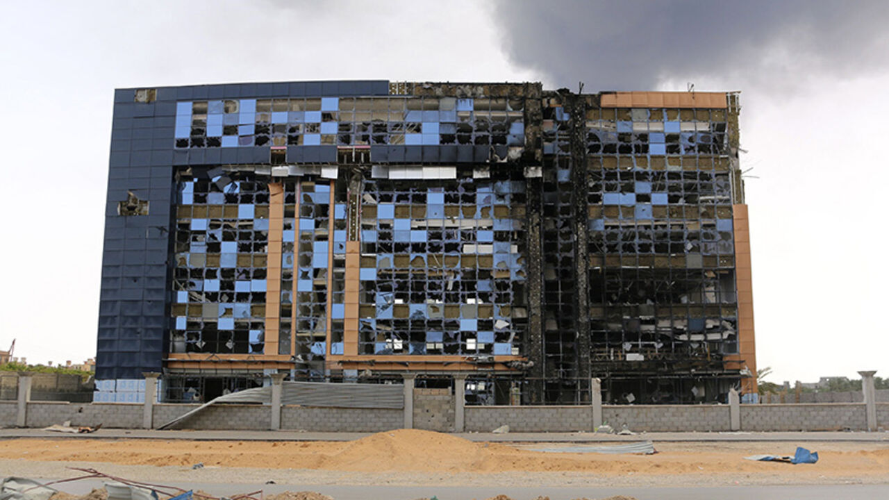 A damaged building is pictured after clashes between rival militias, in an area at Alswani road in Tripoli July 28, 2014. A rocket hit a fuel storage tank in a chaotic battle for Tripoli airport that has all but closed off international flights to Libya, leaving fire-fighters struggling to extinguish a giant conflagration. Two rival brigades of former rebels fighting for control of Tripoli International Airport have pounded each other's positions with Grad rockets, artillery fire and cannons for two weeks, 