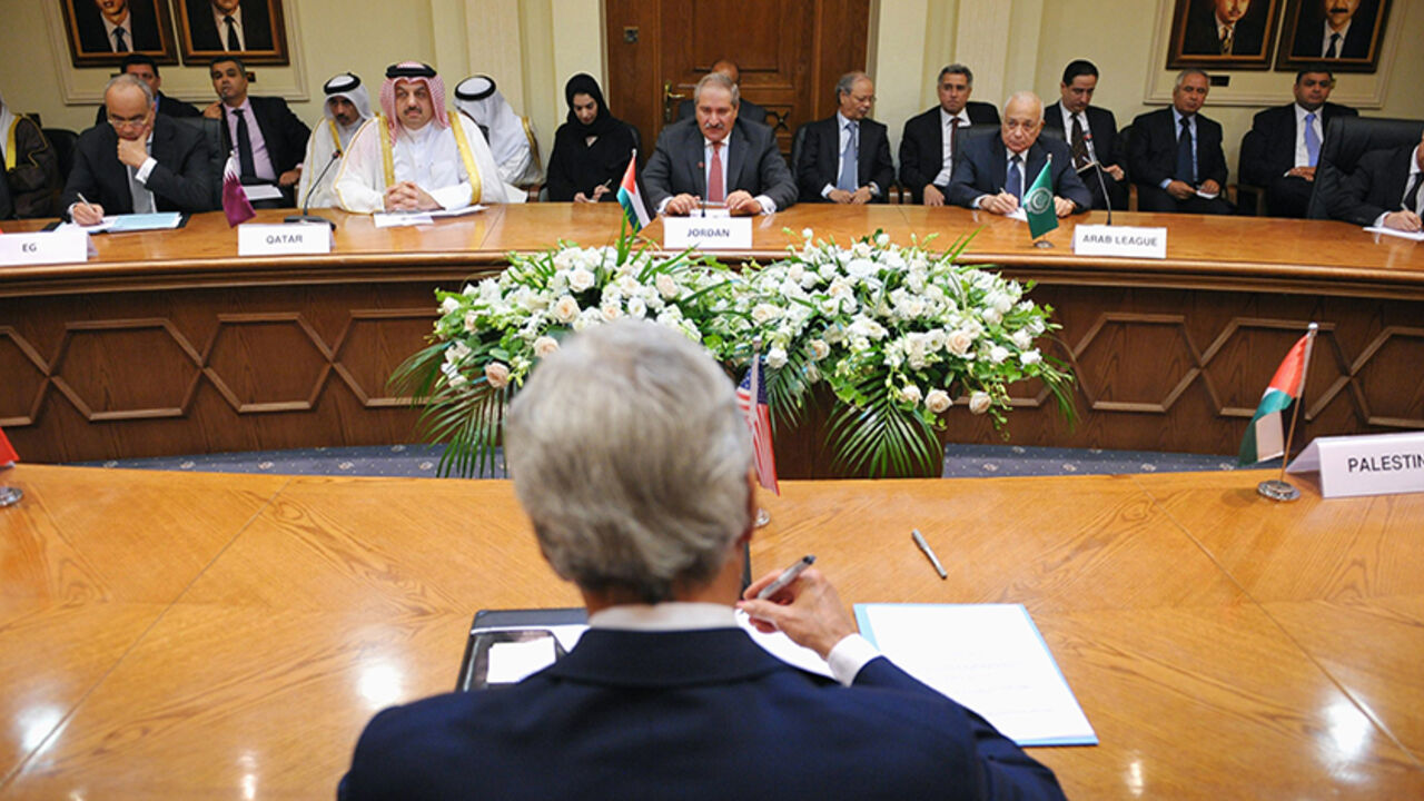 U.S. Secretary of State John Kerry (back to camera) meets with the Arab League Peace Initiative at the Ministry of Foreign Affairs in Amman, July 17, 2013. Kerry is due to meet on Wednesday with officials from Arab nations that he regards as essential to his push to get Israelis and Palestinians to resume peace talks. REUTERS/Mandel Ngan/Pool (JORDAN - Tags: POLITICS) - RTX11P6I
