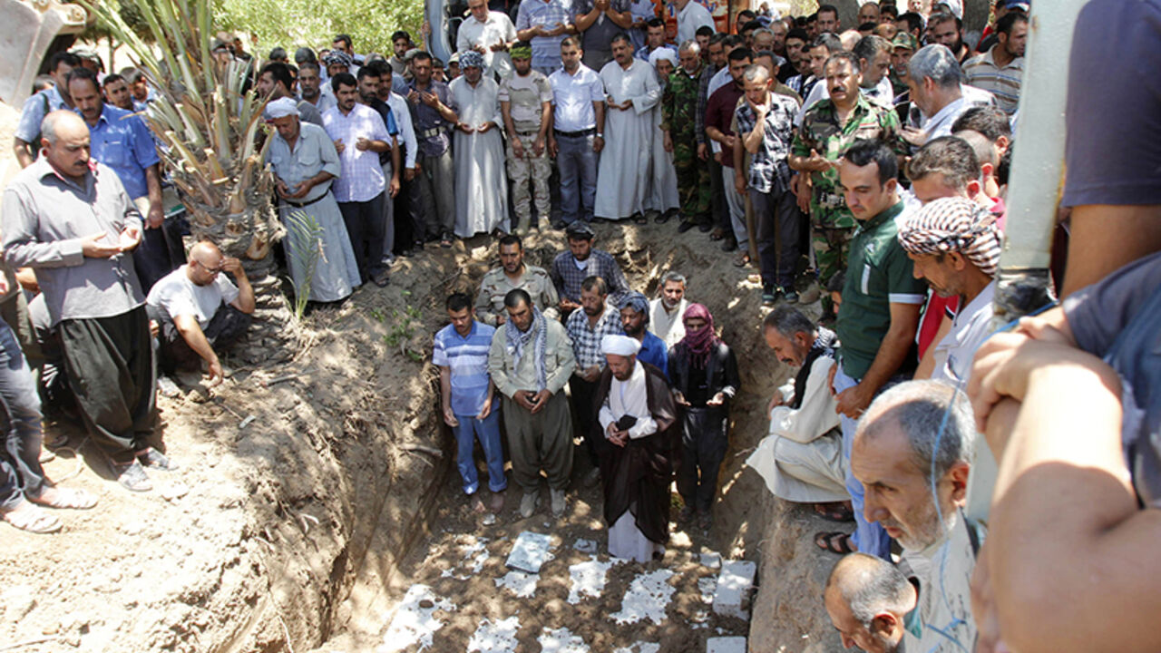 Mourners pray during a funeral in Kirkuk, June 23, 2014. About 15 Iraqi Turkmen Shi'ites were killed by militants from the Islamic State in Iraq and the Levant (ISIL) in Tuz Khurmato, relatives of the deceased said. REUTERS/Ako Rasheed (IRAQ - Tags: CIVIL UNREST POLITICS) - RTR3VAT2