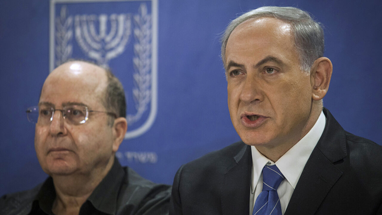 Israel's Prime Minister Benjamin Netanyahu (R) and Defence Minister Moshe Yaalon attend a cabinet meeting in Tel Aviv July 31, 2014. Netanyahu, facing international alarm over a rising civilian death toll in Gaza, said on Thursday he would not accept any ceasefire that stopped Israel completing the destruction of militants' infiltration tunnels. Gaza officials say at least 1,372 Palestinians, most of them civilians, have been killed in the battered territory and nearly 7,000 wounded. Fifty-six Israeli soldi