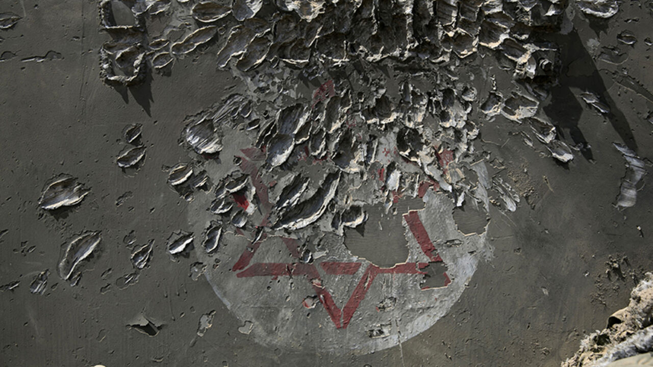 An armoured military ambulance damaged in a Palestinian mortar strike is seen near the border with the Gaza Strip August 4, 2014. Palestinians accused Israel of breaking its own ceasefire on Monday by launching a bomb attack on a refugee camp in Gaza City that killed an eight-year-old girl and wounded 29 other people. An Israeli military spokeswoman said she was checking the report. REUTERS/Baz Ratner (ISRAEL - Tags: POLITICS CIVIL UNREST MILITARY CONFLICT TPX IMAGES OF THE DAY) - RTR415KM