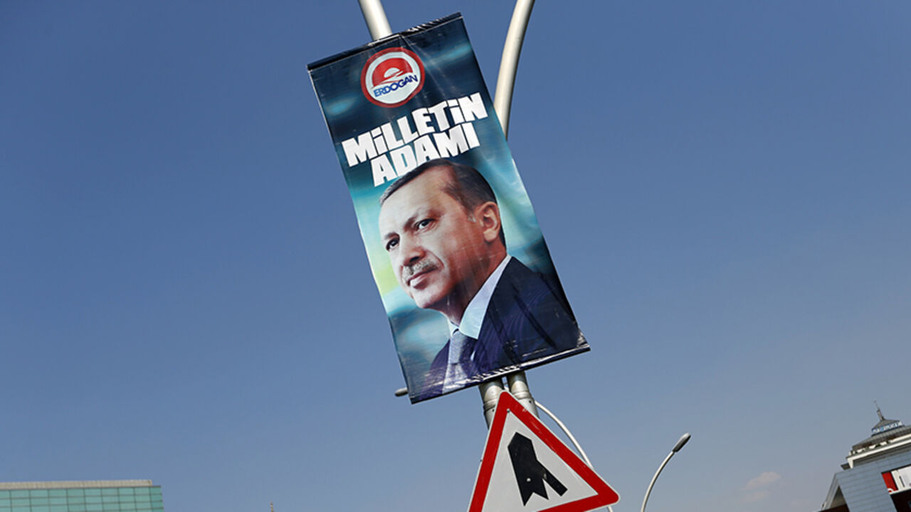 A presidential election campaign banner of Turkey's Prime Minister Tayyip Erdogan, with a slogan that reads "Man of the nation", hangs on a street near his ruling AK Party headquarters in Ankara August 11, 2014. Turkey's ruling party begins deliberations on the shape of the next government on Monday after Erdogan secured his place in history by winning the nation's first direct presidential election. Erdogan's victory in Sunday's vote takes him a step closer to the executive presidency he has long coveted f
