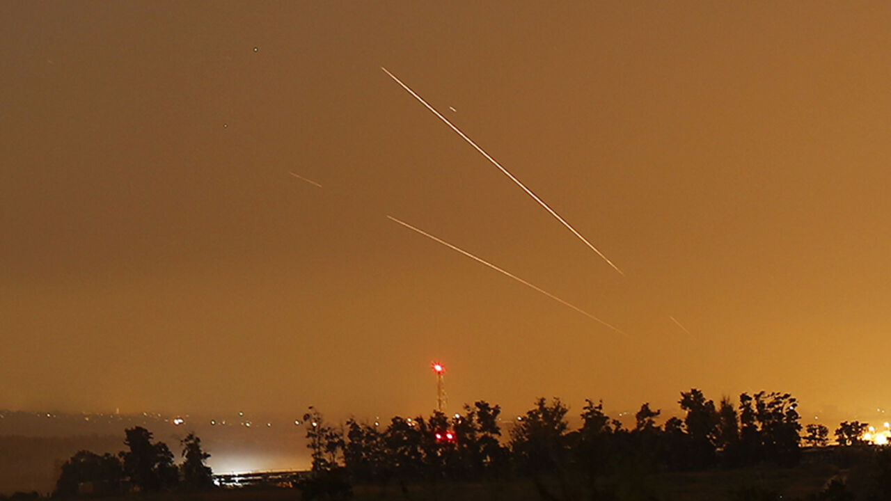 Light streaks and trails are seen as rockets are launched from Gaza towards Israel before a 72-hour cease fire was due to expire August 13, 2014. At least two rockets fired from the Gaza Strip struck Israel on Wednesday, moments before a three-day truce was set to expire, police said. Spokesman Micky Rosenfeld said two rockets landed in open areas causing no damage or casualties. The attacks occurred as Palestinians announced agreement to extend a truce expiring at 2100 gmt Wednesday for another five days. 