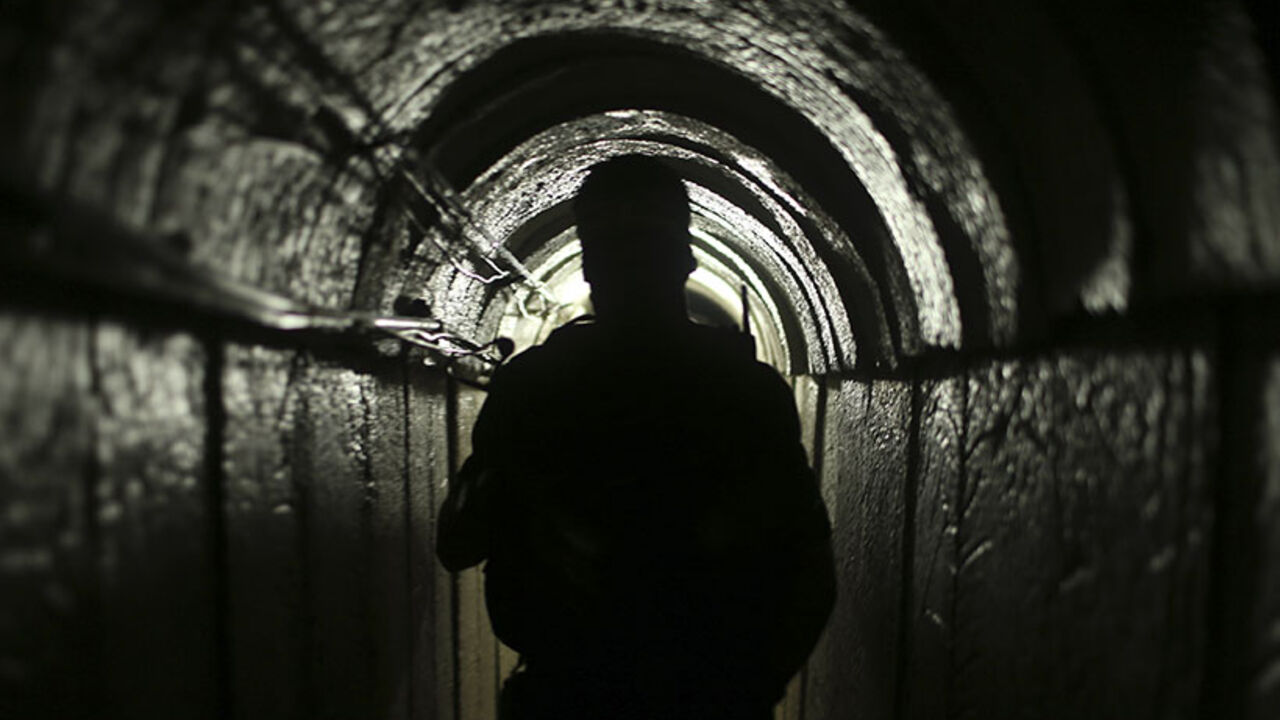 A Palestinian fighter from the Izz el-Deen al-Qassam Brigades, the armed wing of the Hamas movement, is seen inside an underground tunnel in Gaza August 18, 2014. A rare tour that Hamas granted to a Reuters reporter, photographer and cameraman appeared to be an attempt to dispute Israel's claim that it had demolished all of the Islamist group's border infiltration tunnels in the Gaza war. Picture taken August 18, 2014. To match Exclusive MIDEAST-GAZA/TUNNELS             REUTERS/Mohammed Salem (GAZA - Tags: 