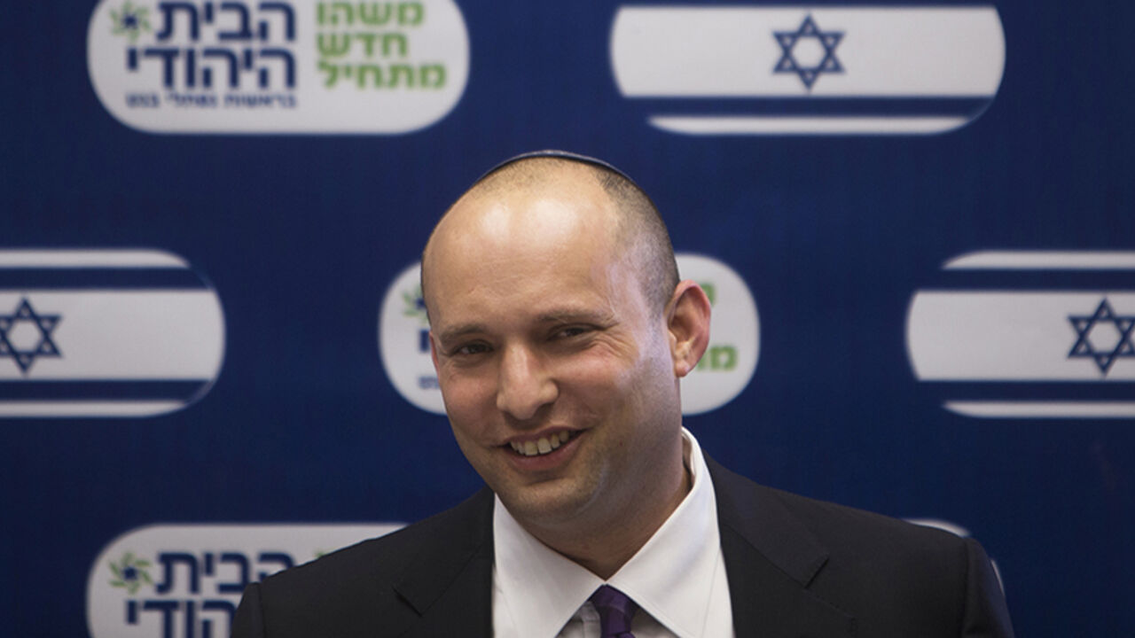 Naftali Bennett (C), smiles during a Jewish Home party meeting, at the Knesset, the Israeli parliament, in Jerusalem March 4, 2013. A surprise alliance between Israeli political stars, far-right Bennett, and centrist Yair Lapid, who reject privileges for ultra-orthodox Jews is frustrating Prime Minister Benjamin Netanyahu's efforts to form a new government. REUTERS/Ronen Zvulun (JERUSALEM - Tags: POLITICS) - RTR3EKA2